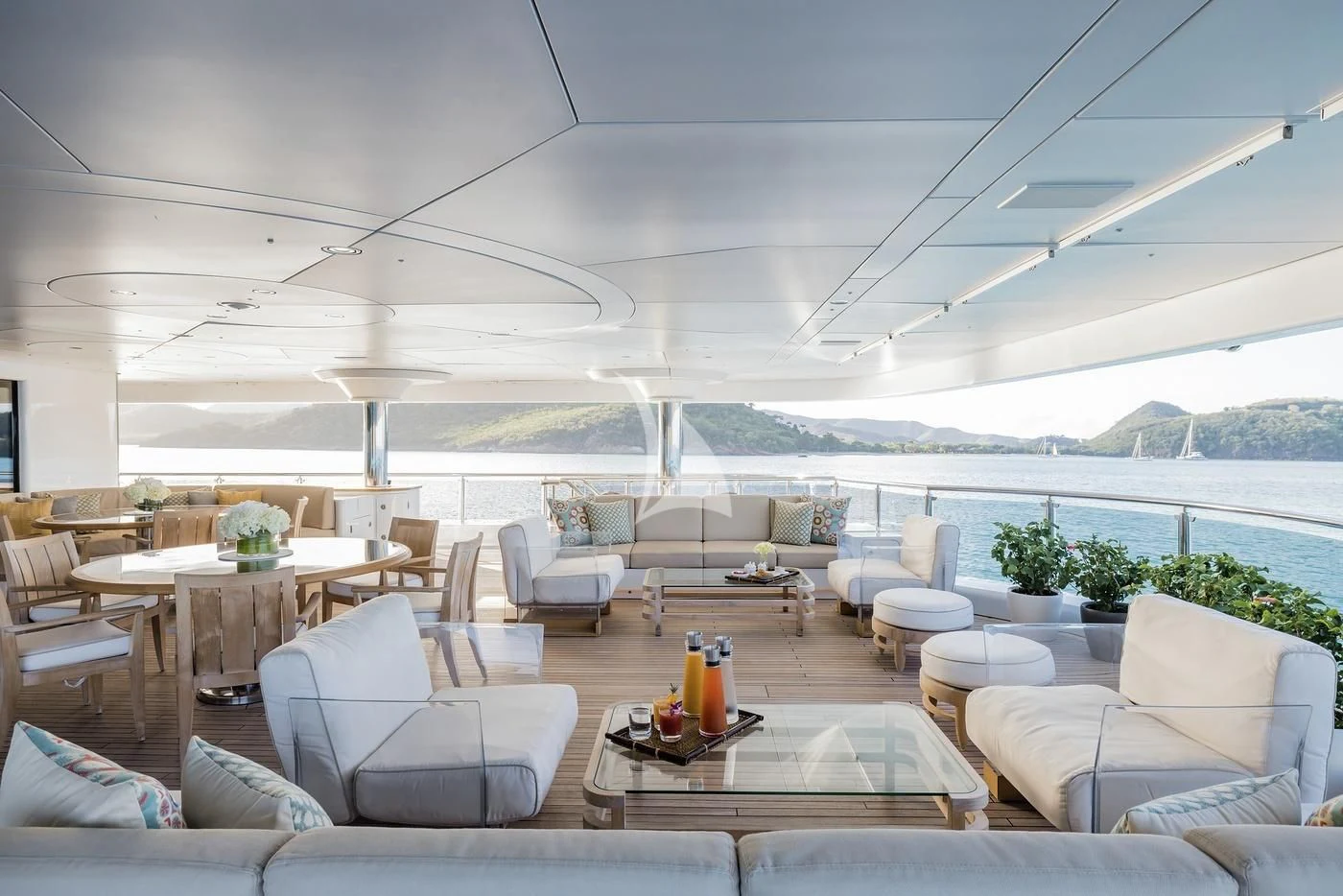 a room with a table chairs and a large window aboard NAIA Yacht for Sale