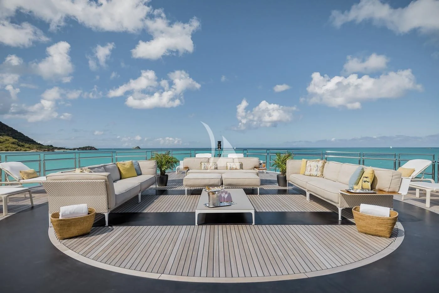 a patio with a table and chairs on it by the ocean aboard NAIA Yacht for Sale