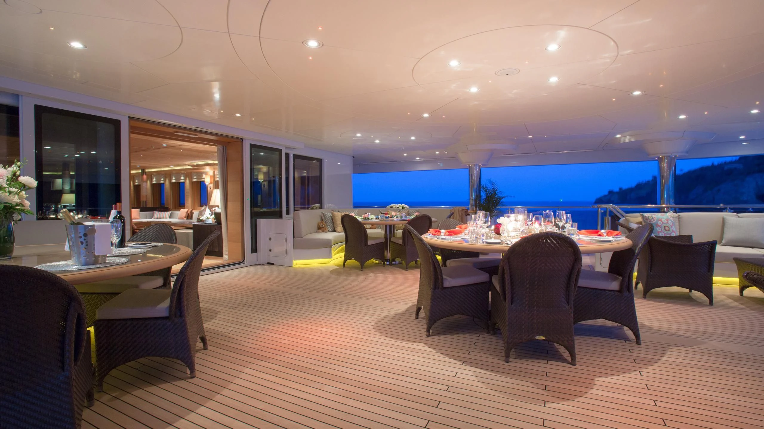 a room with tables and chairs aboard NAIA Yacht for Sale