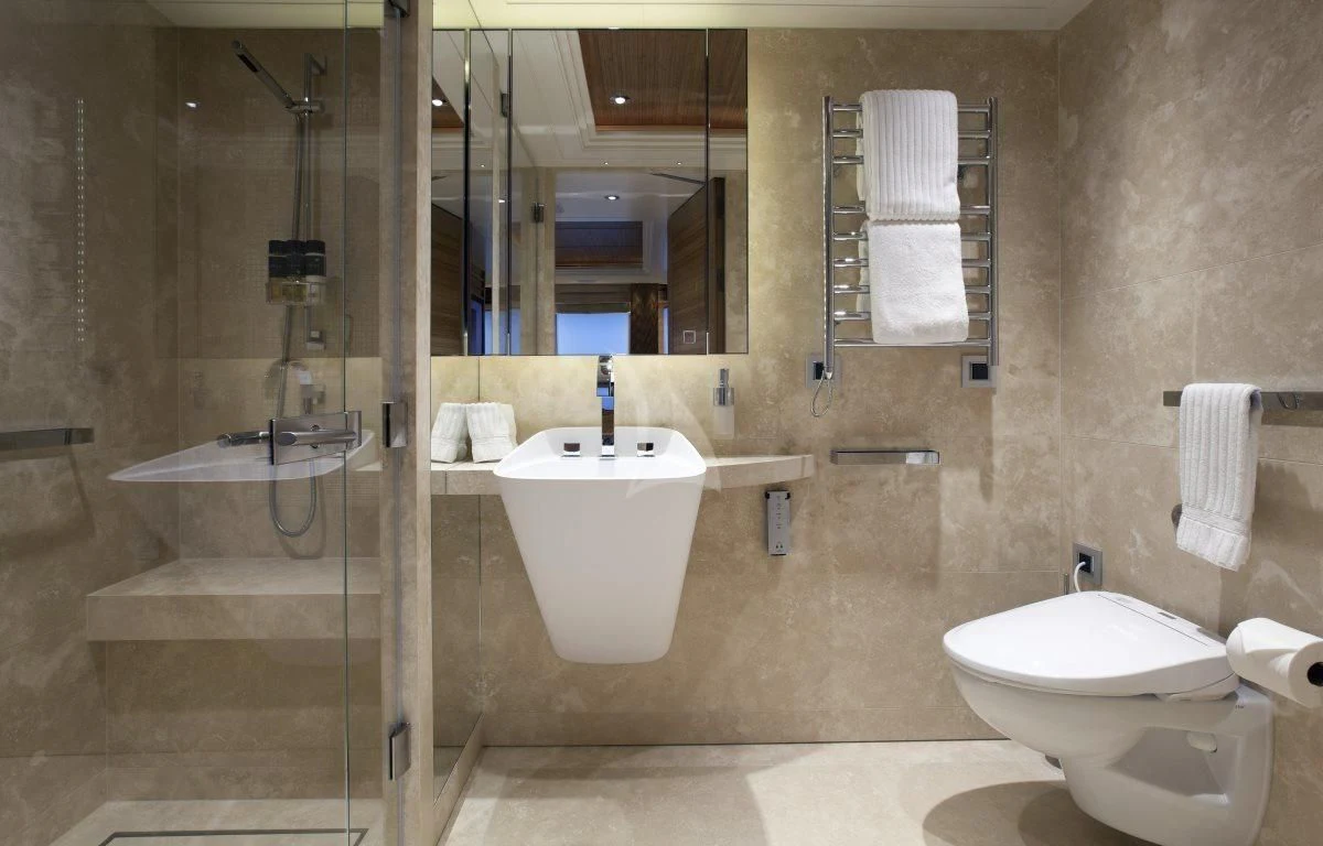 a bathroom with a tub sink and toilet aboard NAIA Yacht for Sale