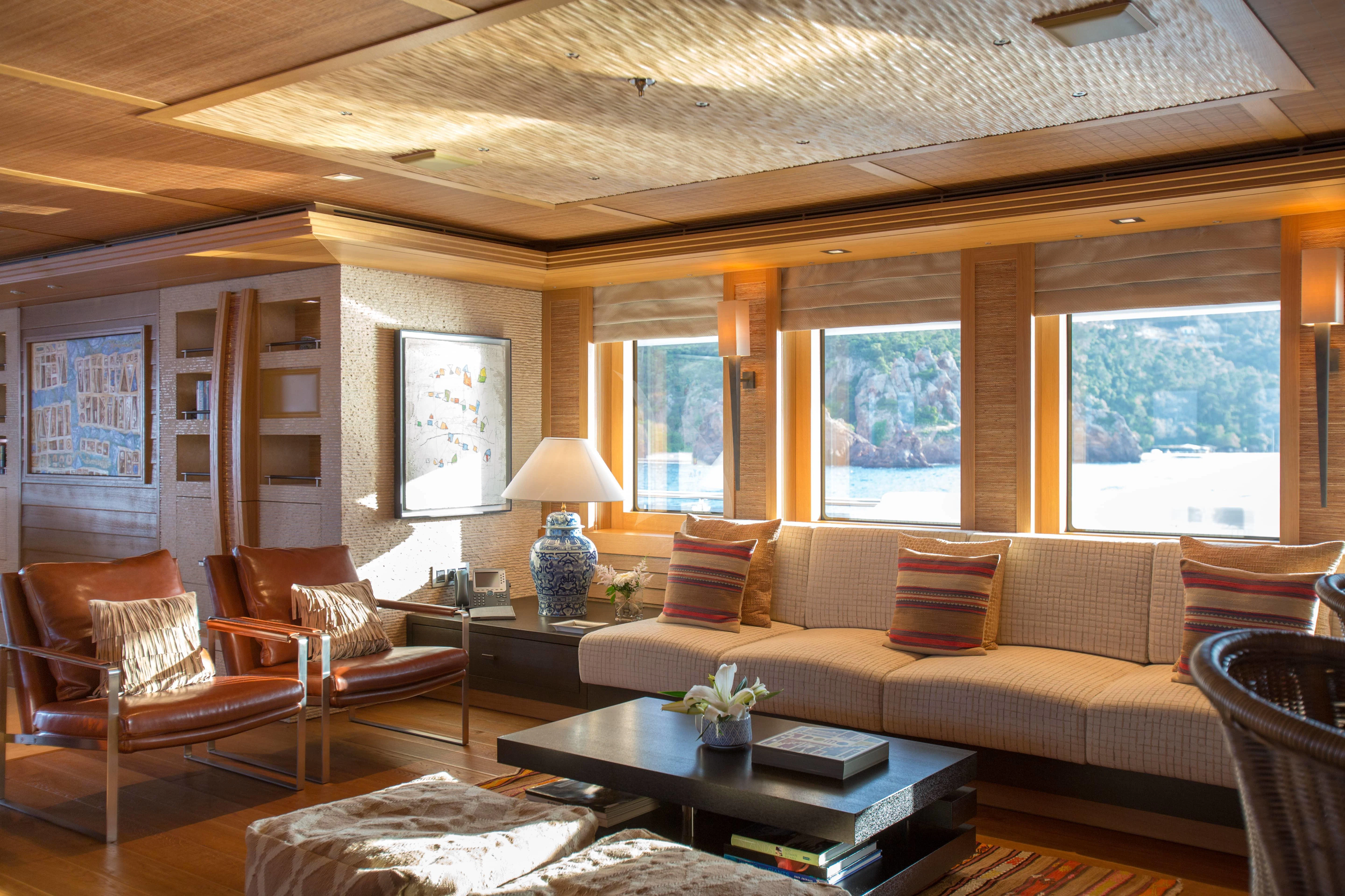 a living room with a couch and a coffee table aboard NAIA Yacht for Sale