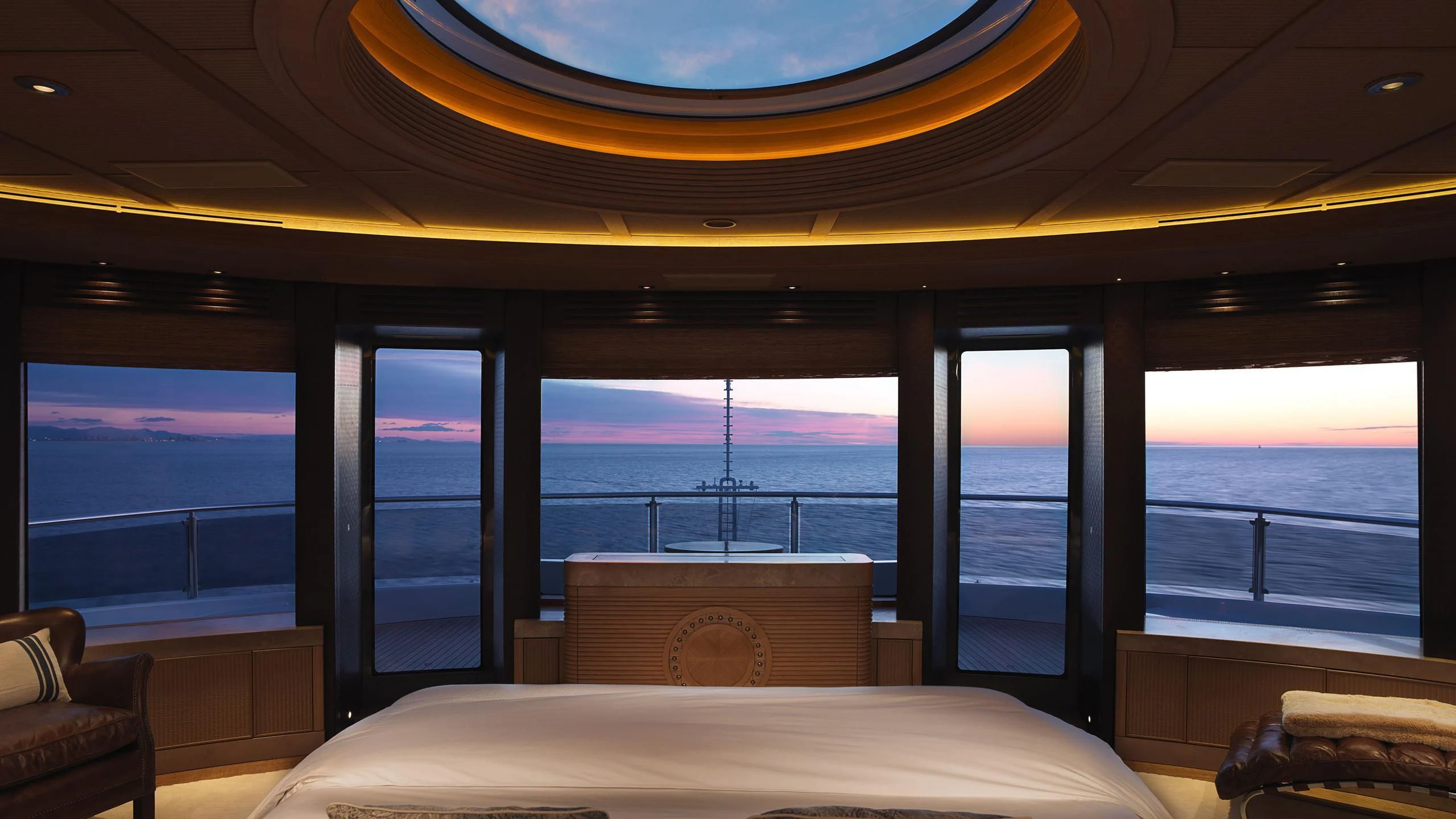 a room with a view of the ocean and a bed aboard NAIA Yacht for Sale