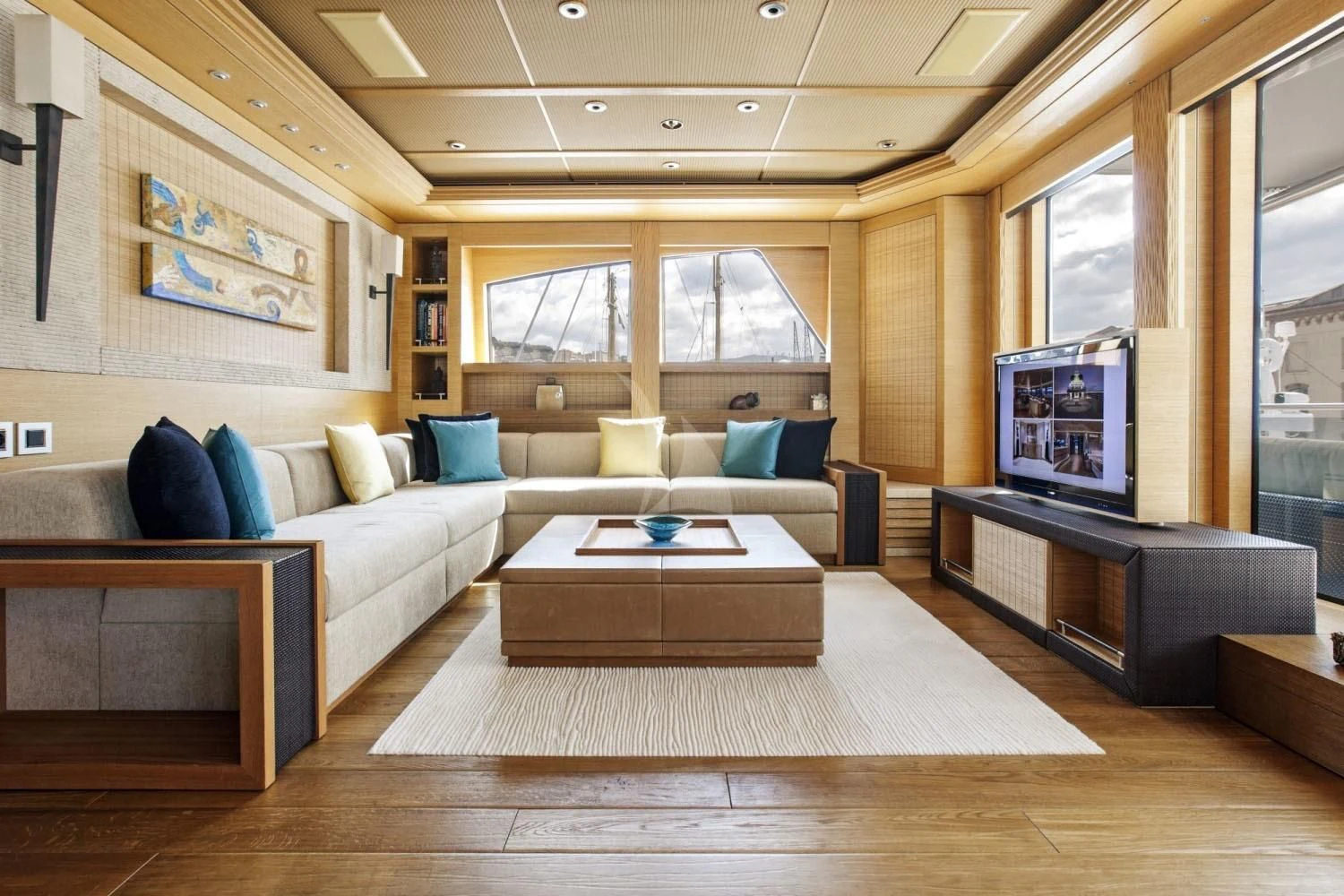 a living room with a large sofa aboard NAIA Yacht for Sale