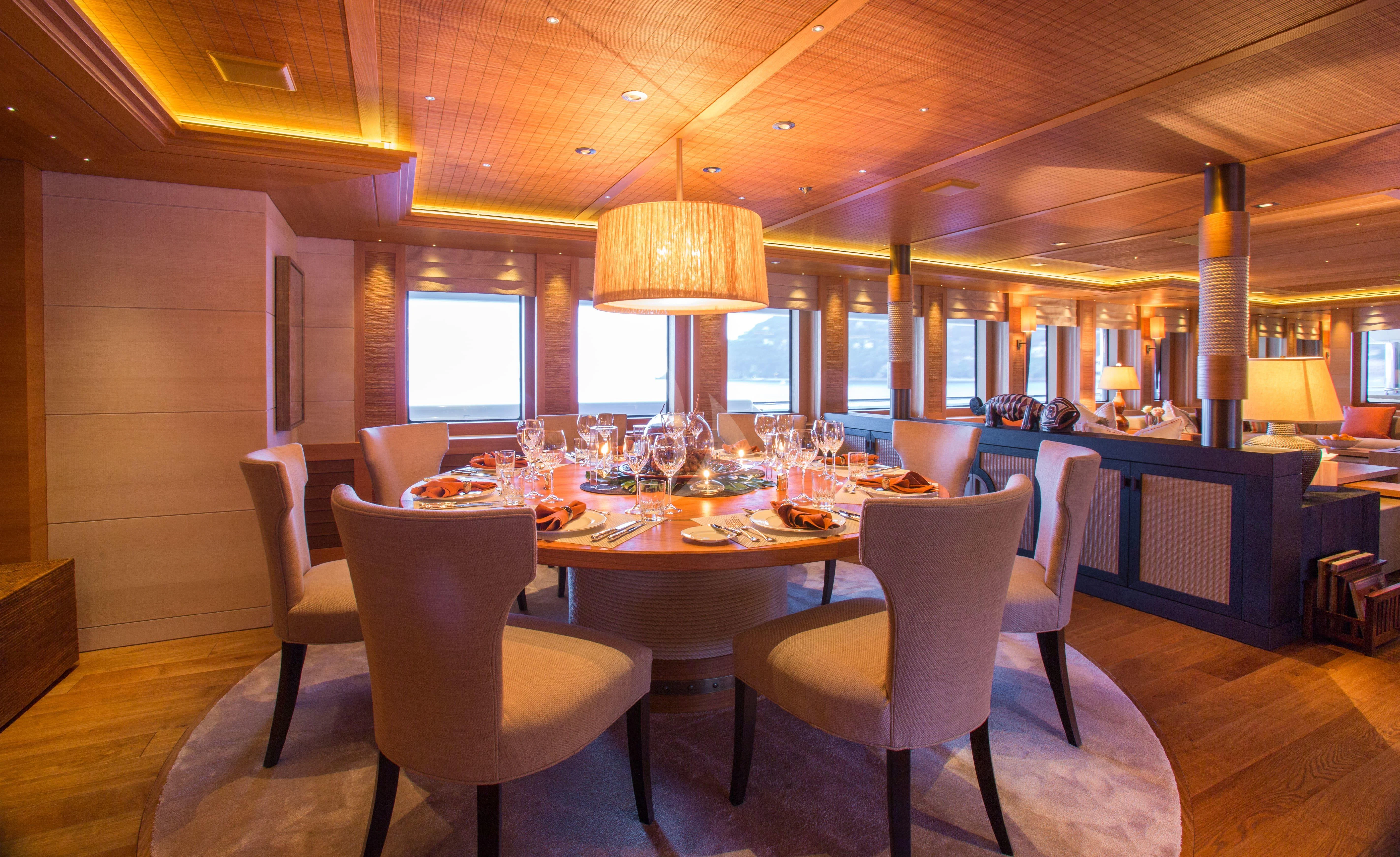 a large dining room with a table and chairs aboard NAIA Yacht for Sale