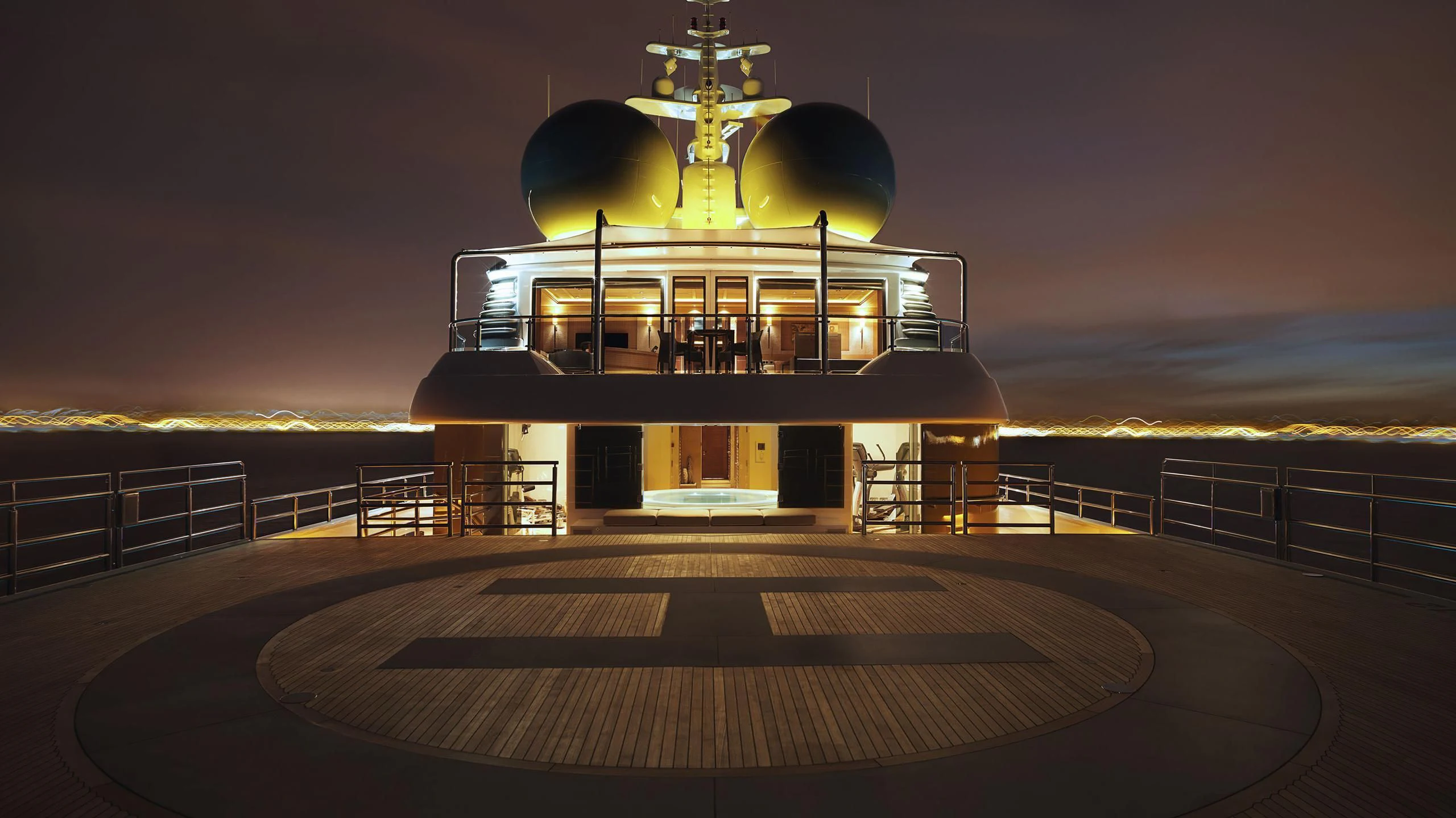 a boat on a dock at night aboard NAIA Yacht for Sale