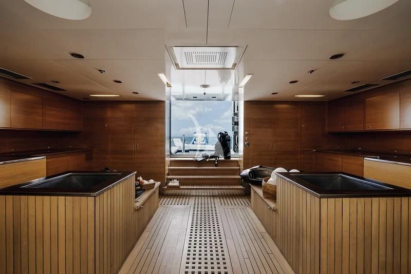 a large kitchen with wooden cabinets aboard NAIA Yacht for Sale