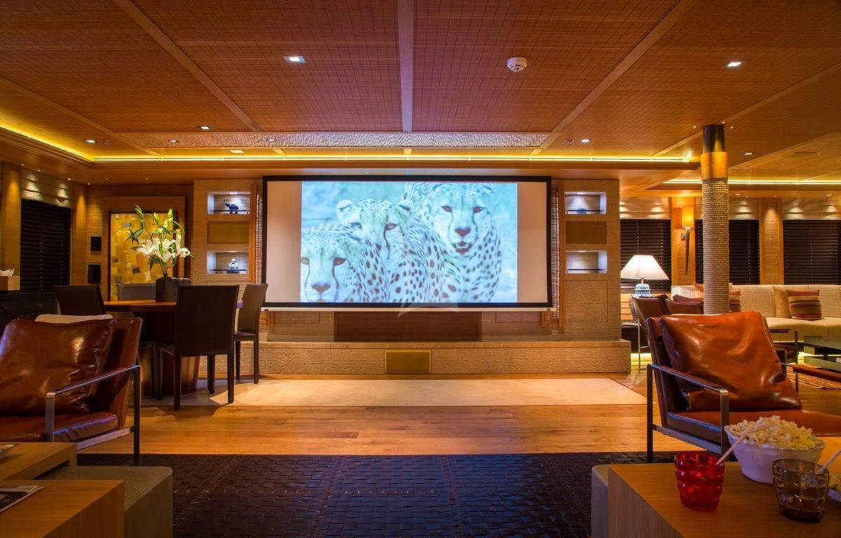 a room with a large screen aboard NAIA Yacht for Sale