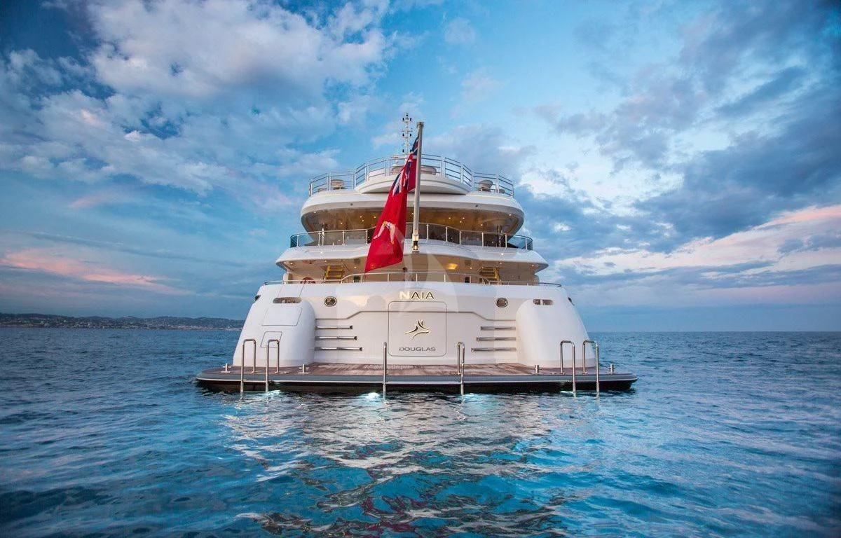 a large white ship in the water aboard NAIA Yacht for Sale