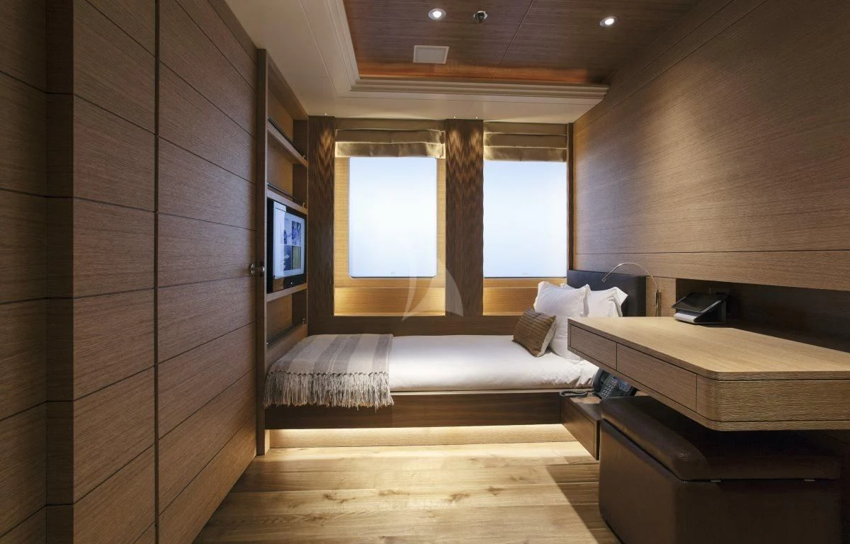 a room with a bed and a tv aboard NAIA Yacht for Sale