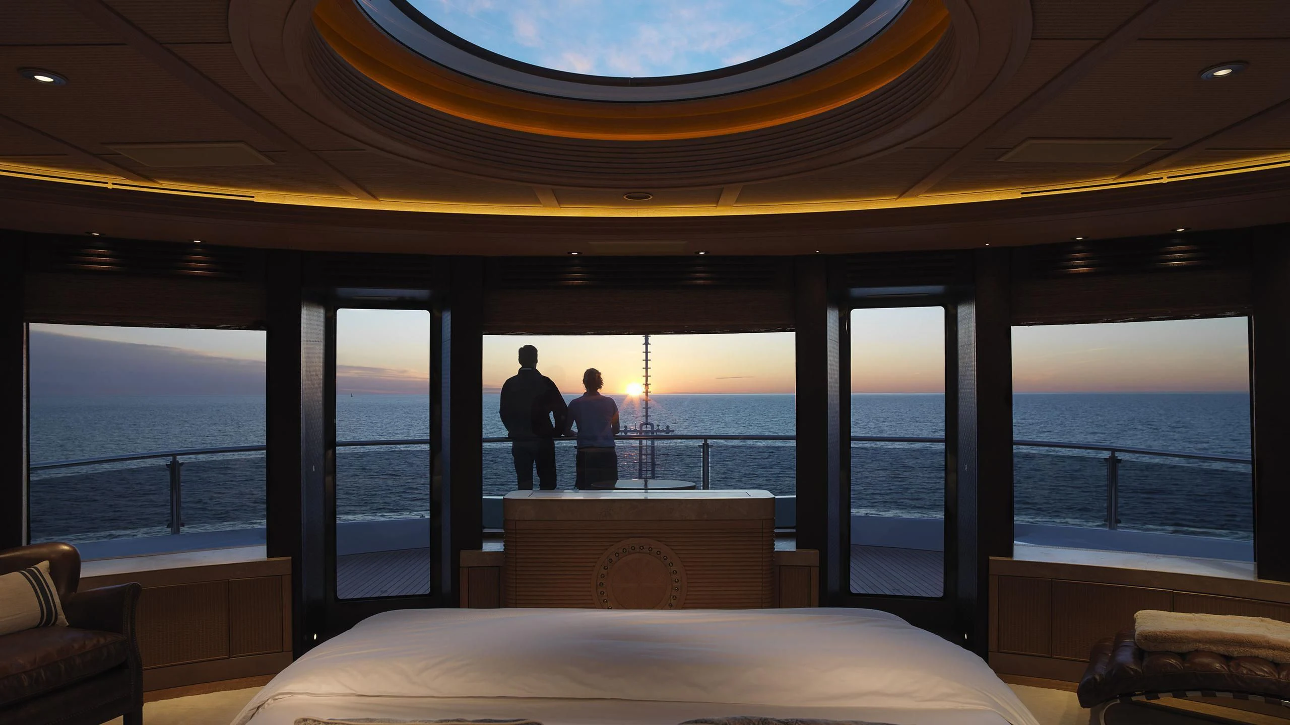 a couple of people looking out a window at the ocean aboard NAIA Yacht for Sale