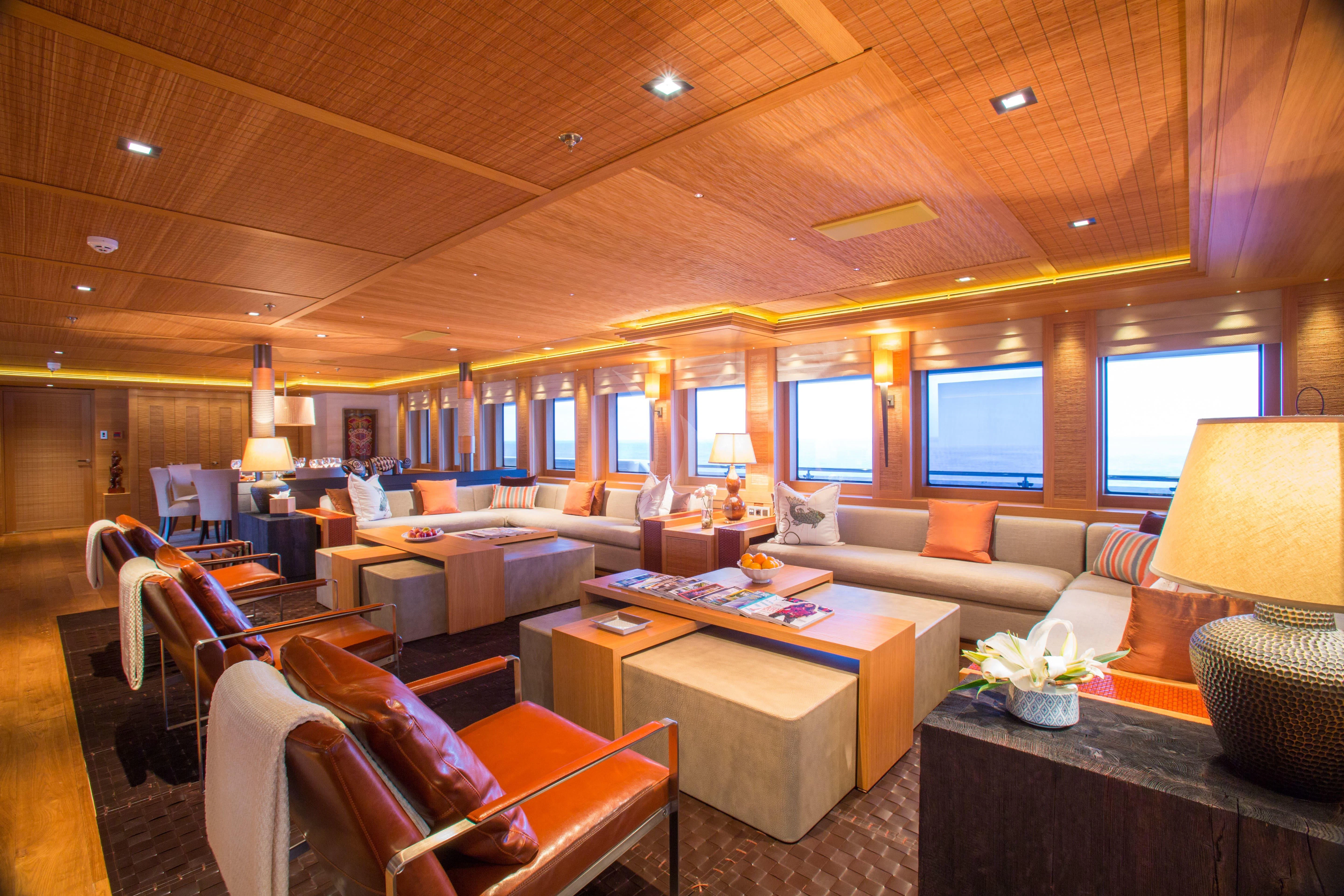 a living room with a large screen aboard NAIA Yacht for Sale