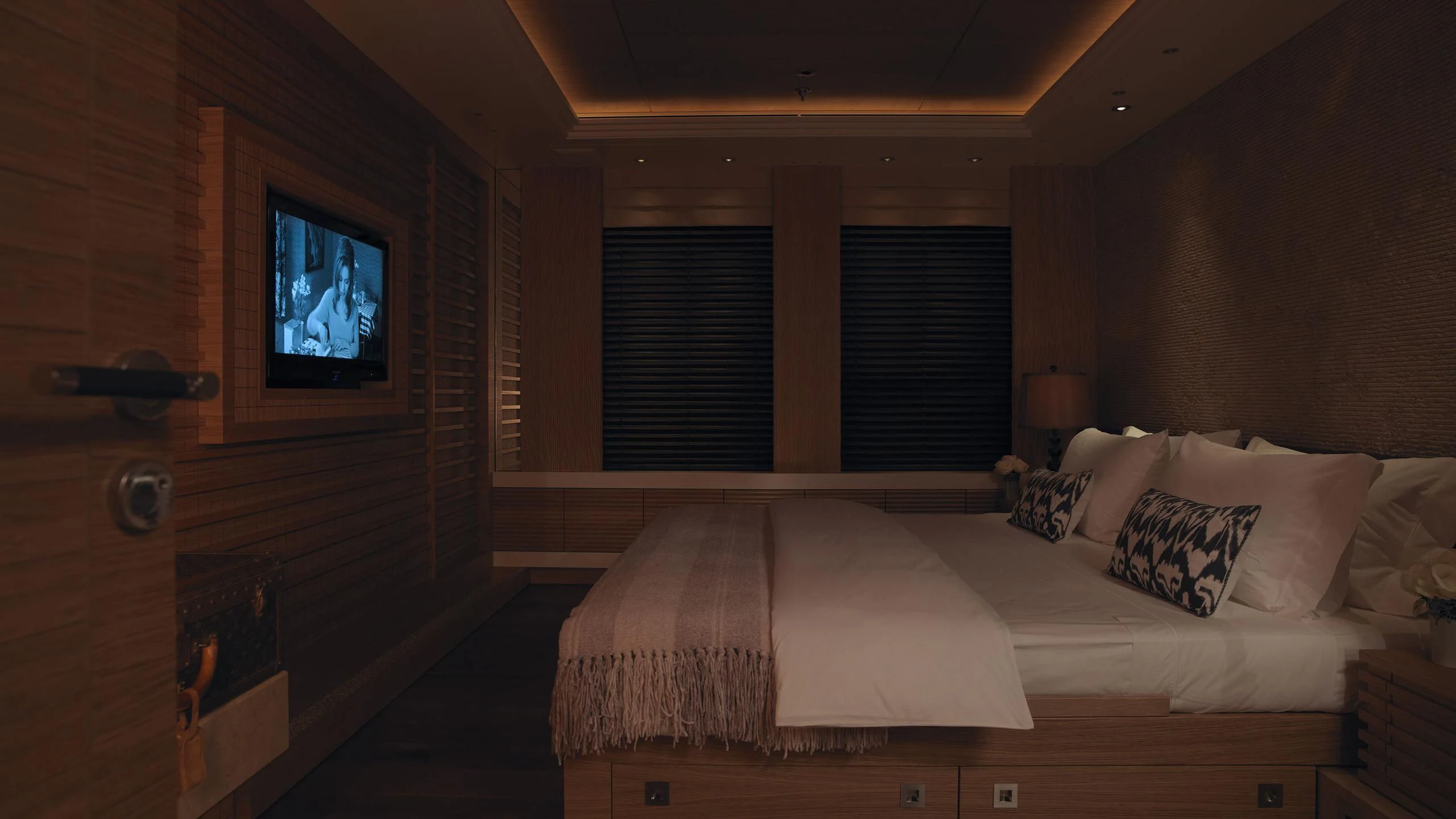 a bedroom with a bed and a television aboard NAIA Yacht for Sale
