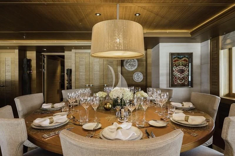 a dining room table set for a formal dinner aboard NAIA Yacht for Sale