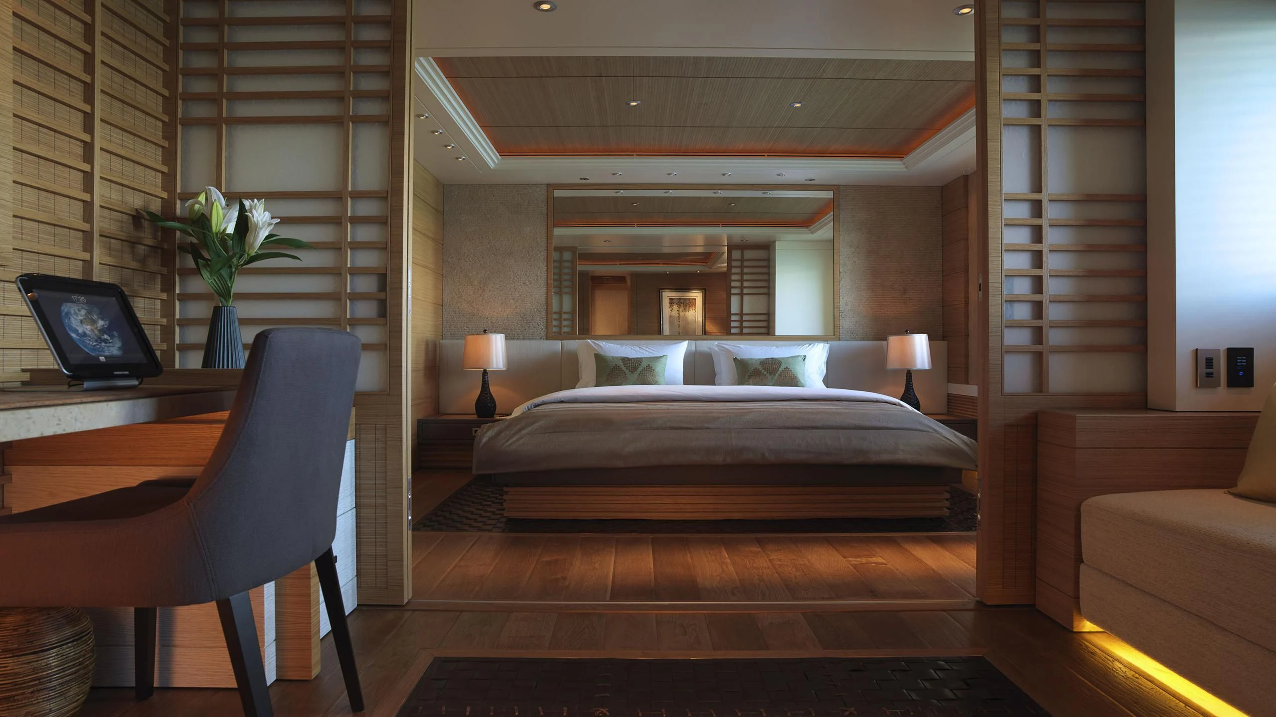 a bedroom with a bed and a laptop aboard NAIA Yacht for Sale