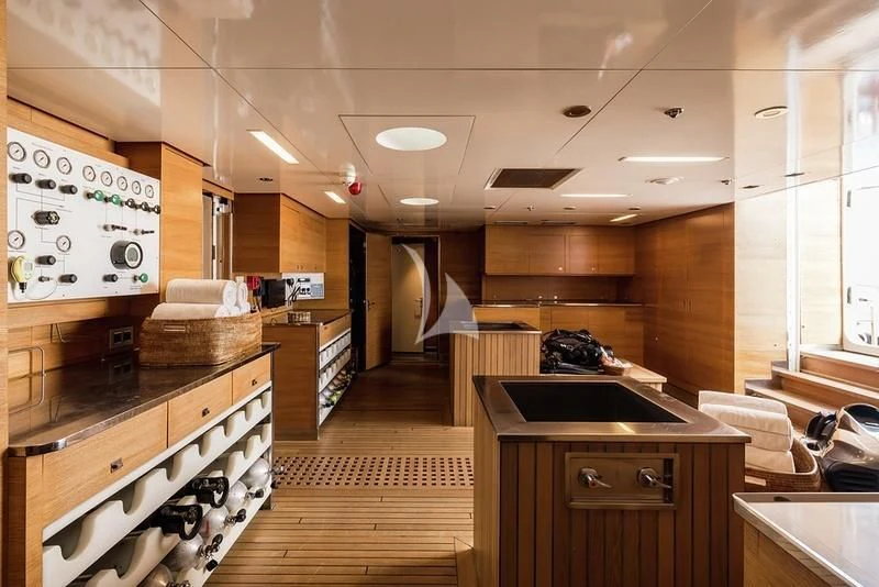 a kitchen with wooden cabinets aboard NAIA Yacht for Sale