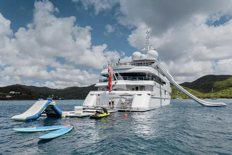 a large white boat in the water aboard NAIA Yacht for Sale