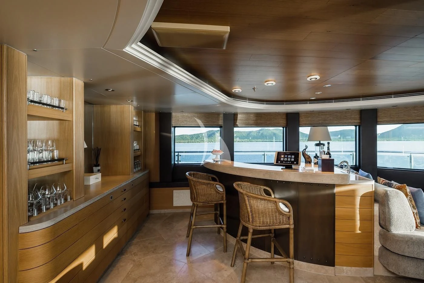 a kitchen with a bar and chairs aboard NAIA Yacht for Sale