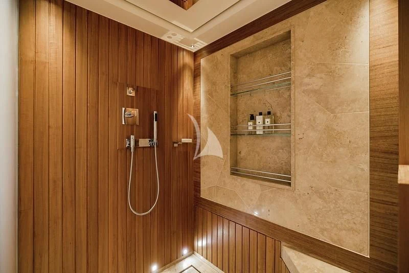 a wooden wall with a glass door aboard NAIA Yacht for Sale