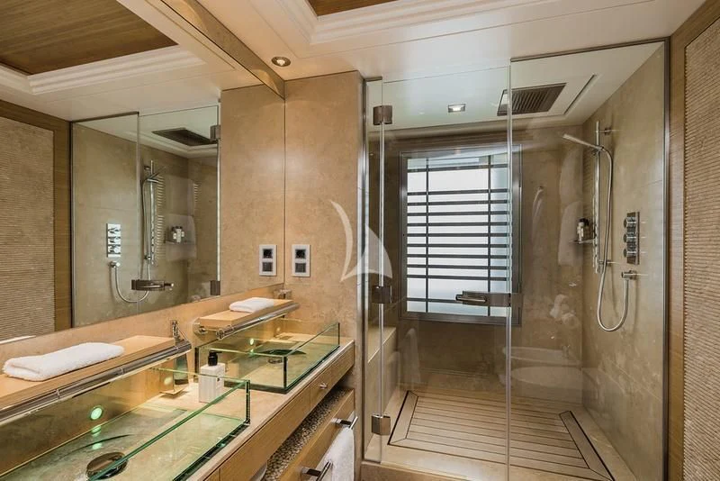a bathroom with a glass shower aboard NAIA Yacht for Sale