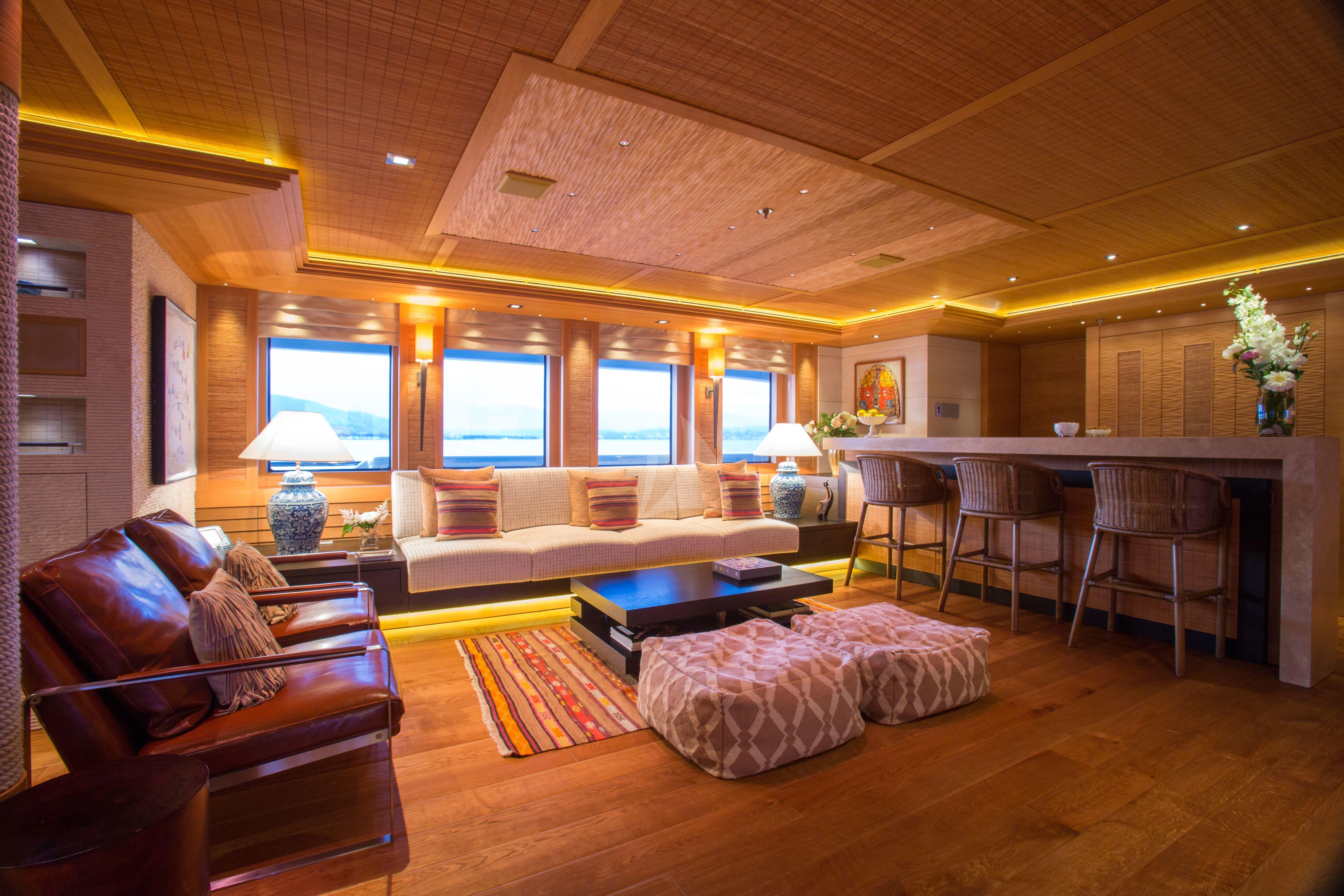 a living room with a couch and a table aboard NAIA Yacht for Sale
