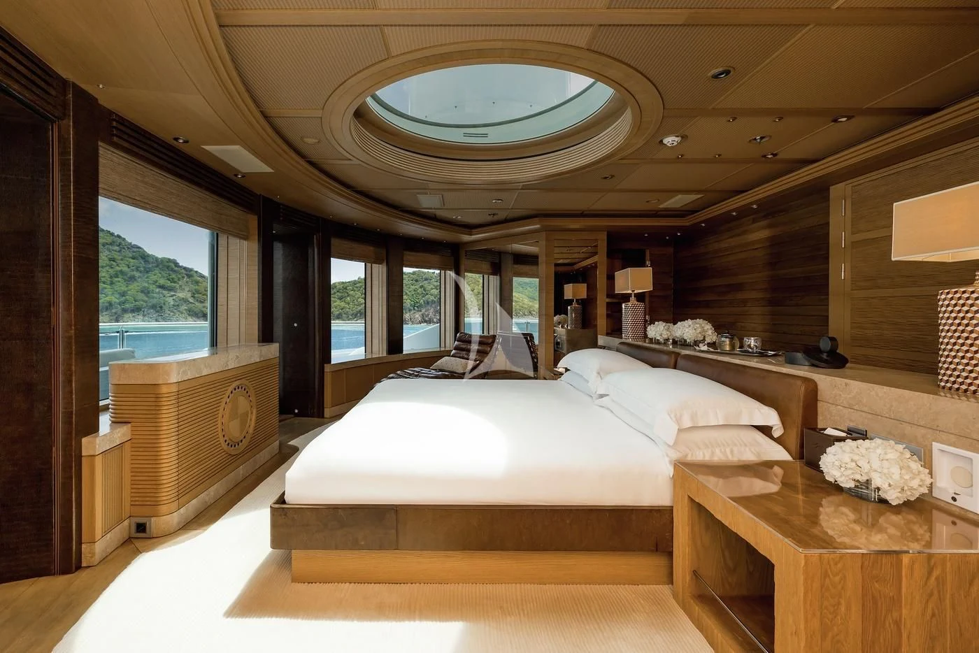 a room with a bed and a table aboard NAIA Yacht for Sale