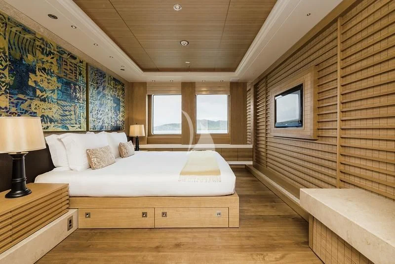 a room with a bed and a window aboard NAIA Yacht for Sale