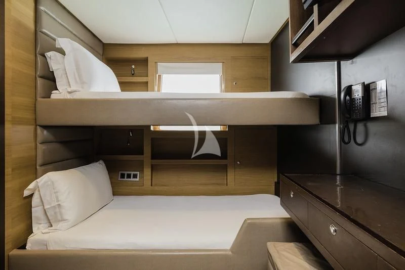 a room with a bed and a desk aboard NAIA Yacht for Sale