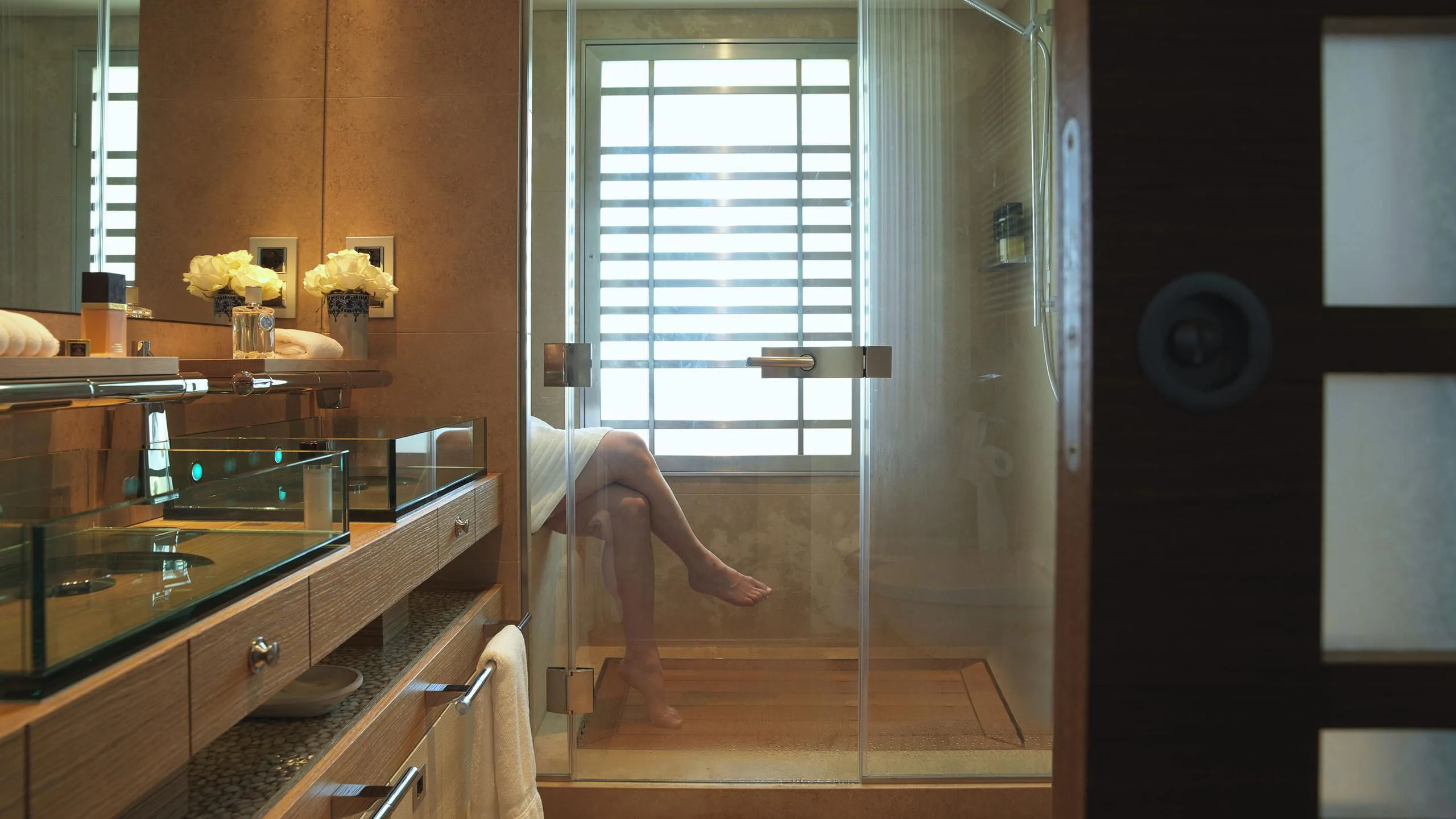 a person's feet on a counter in a bathroom aboard NAIA Yacht for Sale