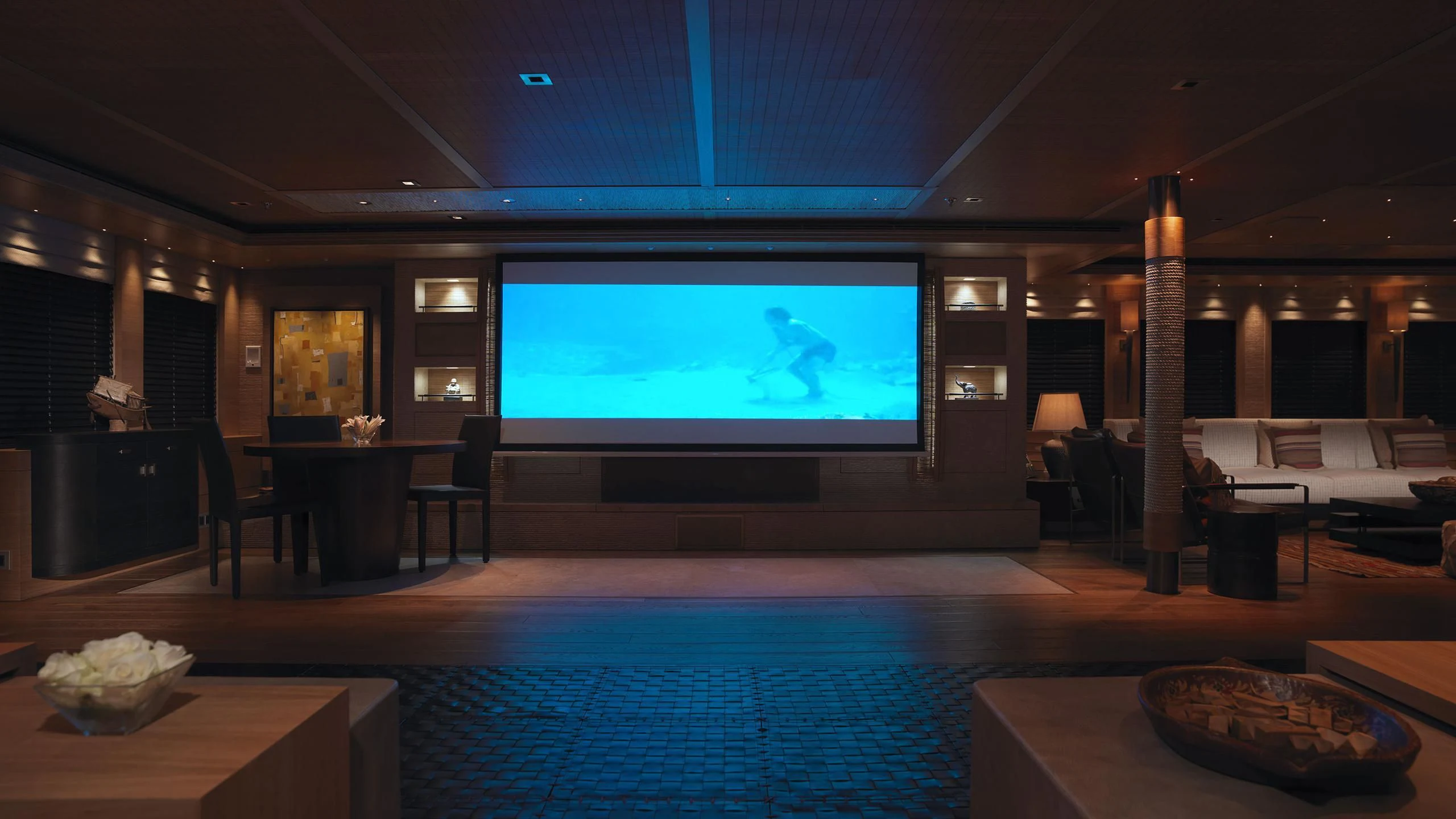 a large room with a large screen aboard NAIA Yacht for Sale
