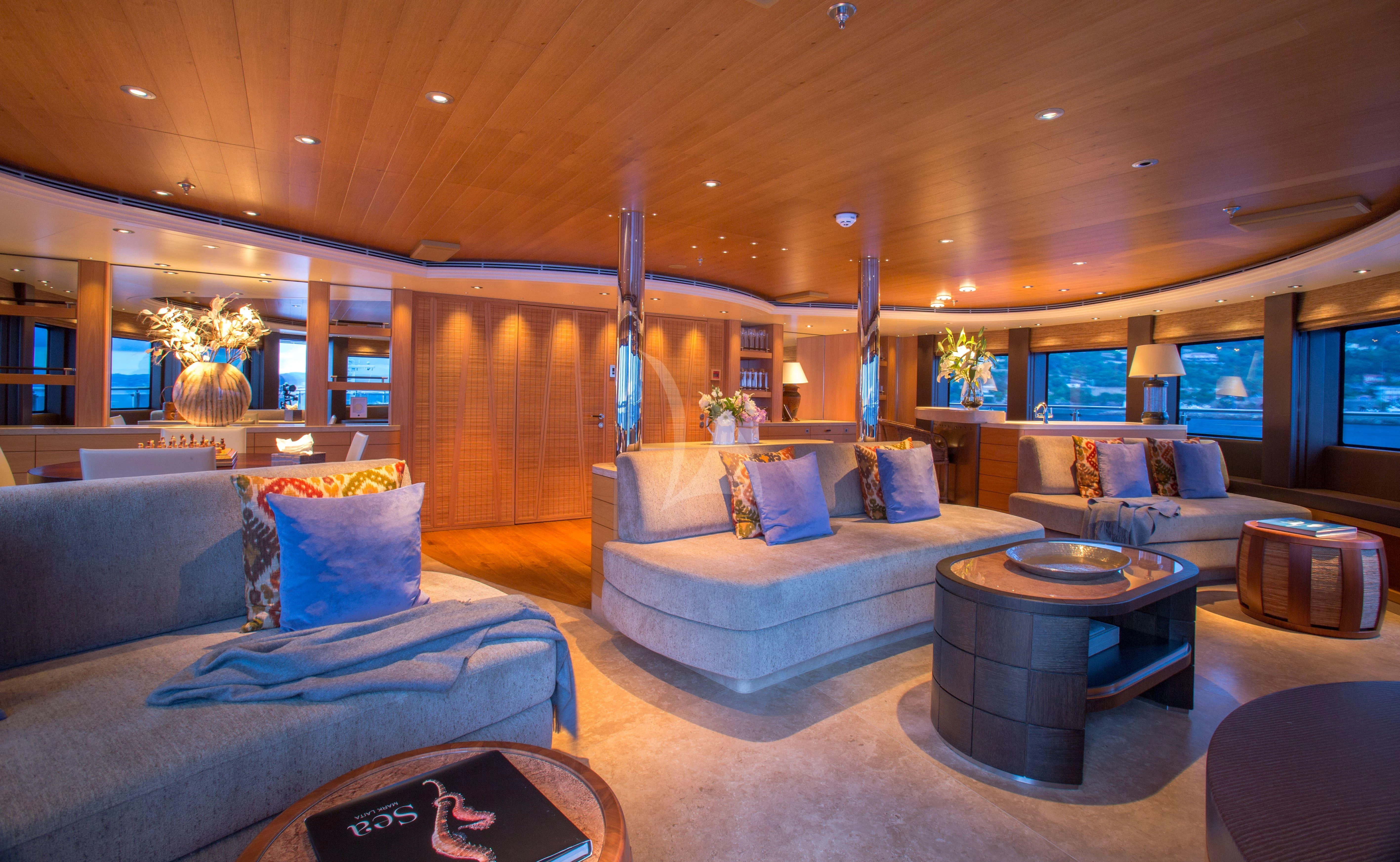 a living room with a couch and a table aboard NAIA Yacht for Sale