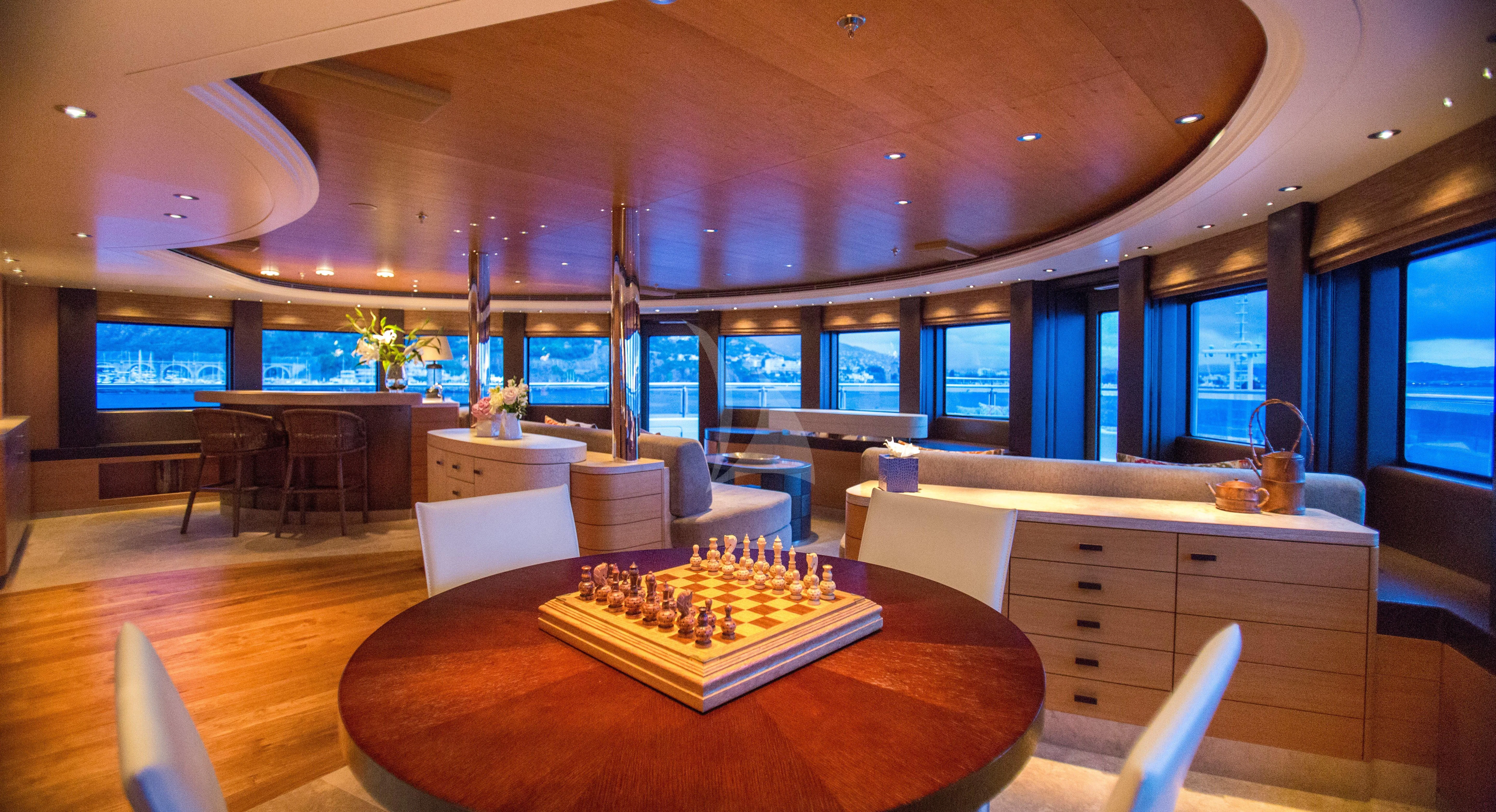 a room with a table and chairs aboard NAIA Yacht for Sale