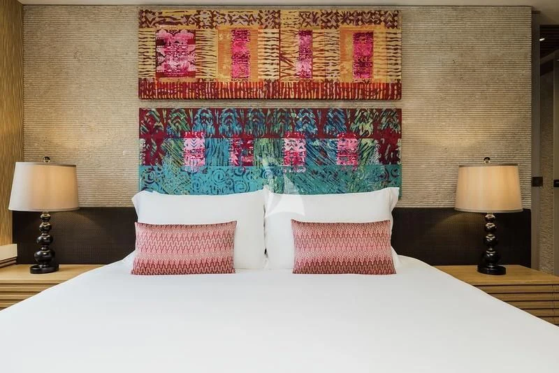 a bed with a colorful blanket aboard NAIA Yacht for Sale