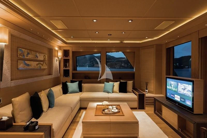 a living room with a large screen aboard NAIA Yacht for Sale