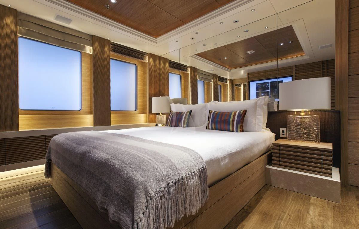 a room with a bed and a television aboard NAIA Yacht for Sale