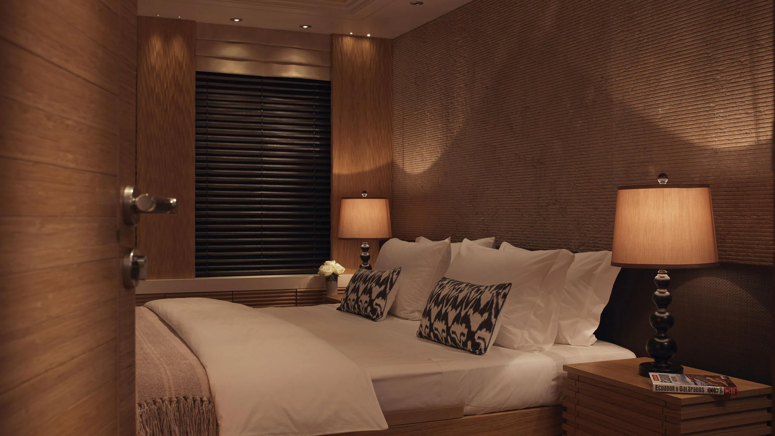 a bed with a lamp on it aboard NAIA Yacht for Sale