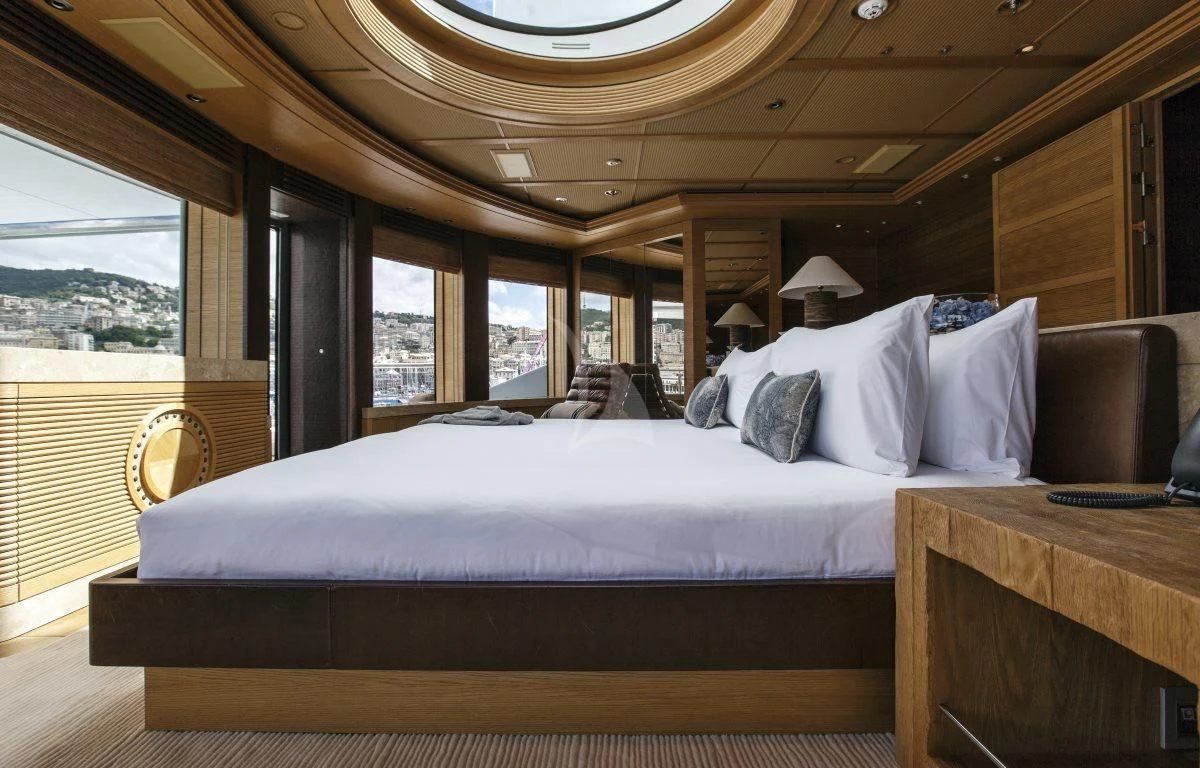 a bed with white sheets aboard NAIA Yacht for Sale
