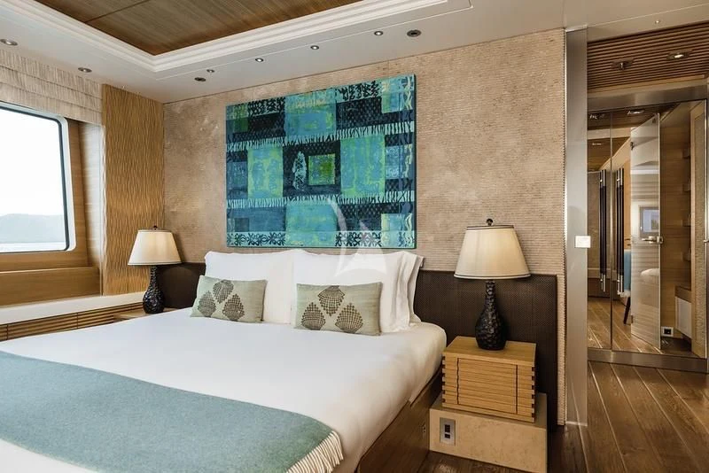 a bedroom with a large bed aboard NAIA Yacht for Sale