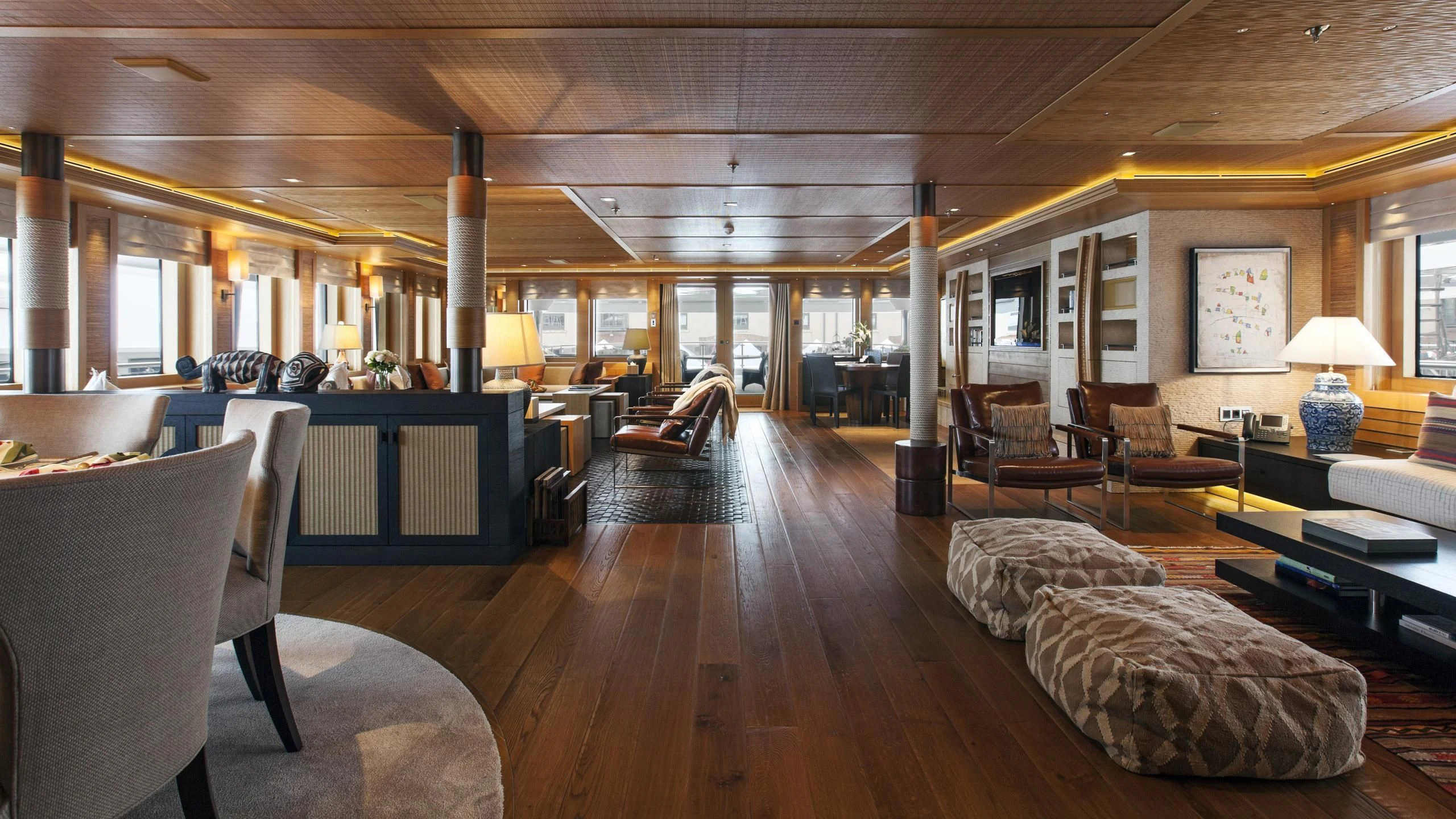 a large living room with wood floors aboard NAIA Yacht for Sale