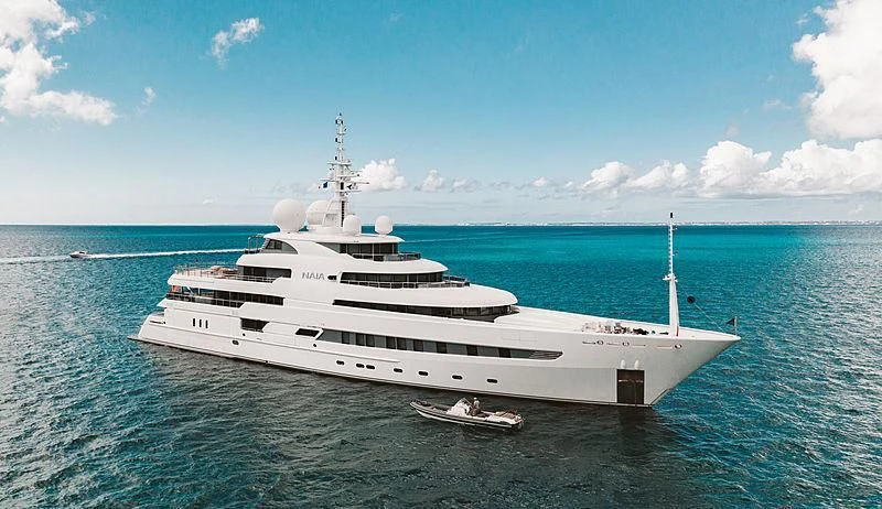 a large white yacht in the water aboard NAIA Yacht for Sale