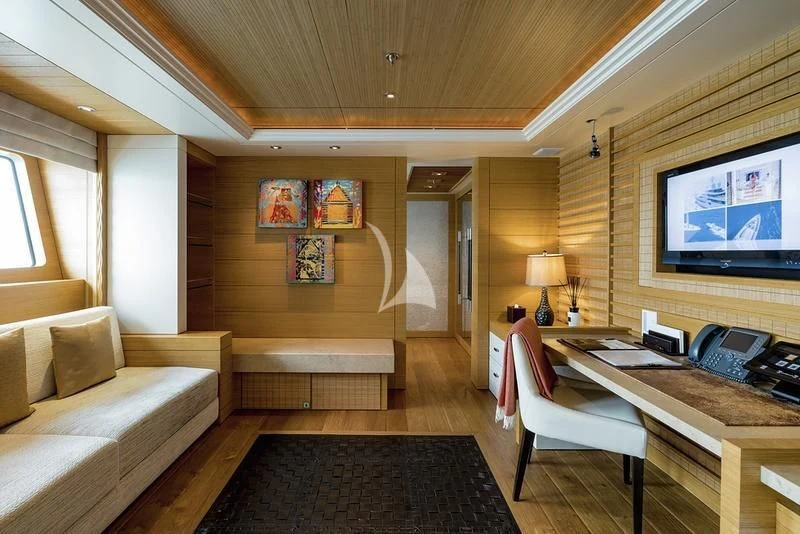 a living room with a couch and a tv aboard NAIA Yacht for Sale