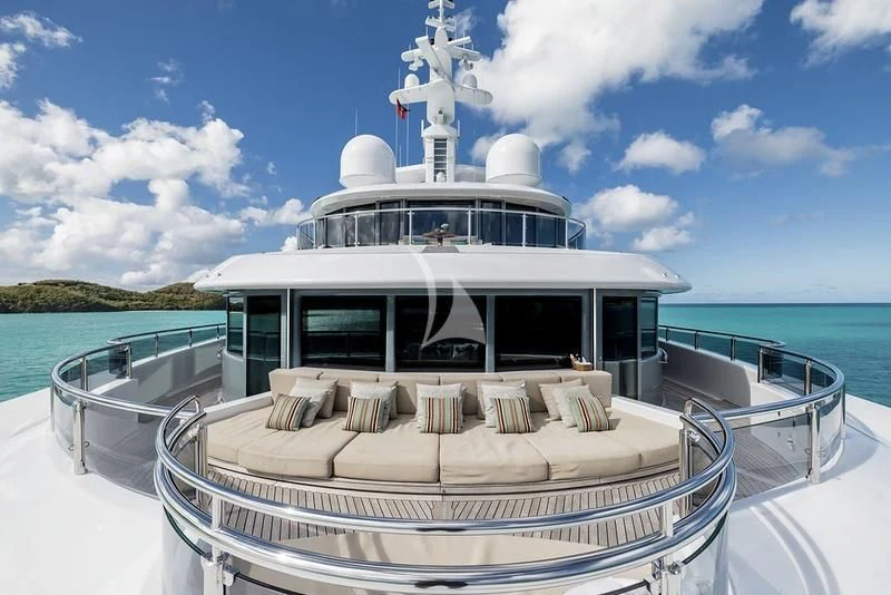 a white boat on a body of water aboard NAIA Yacht for Sale