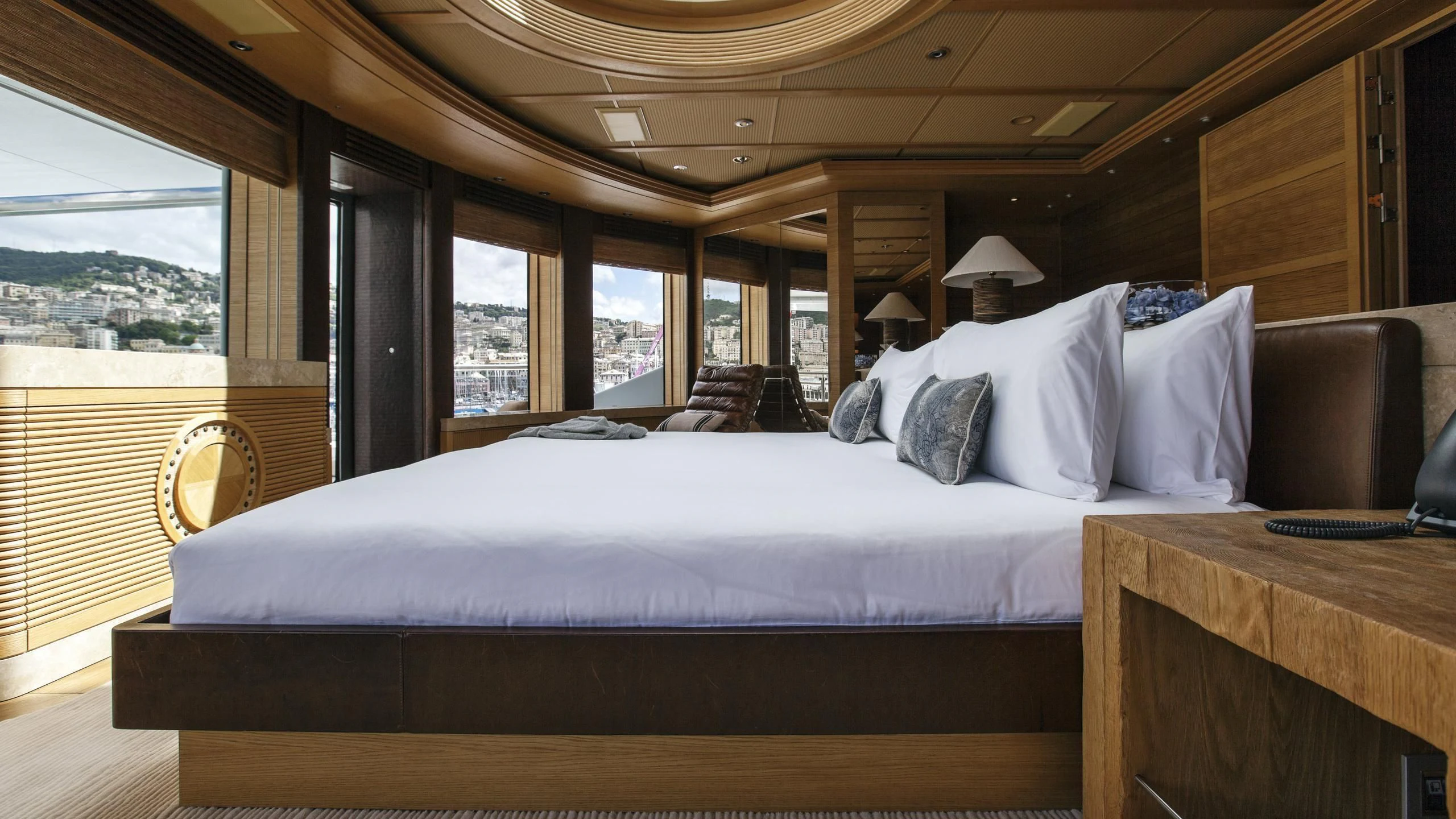 a bed with white sheets aboard NAIA Yacht for Sale