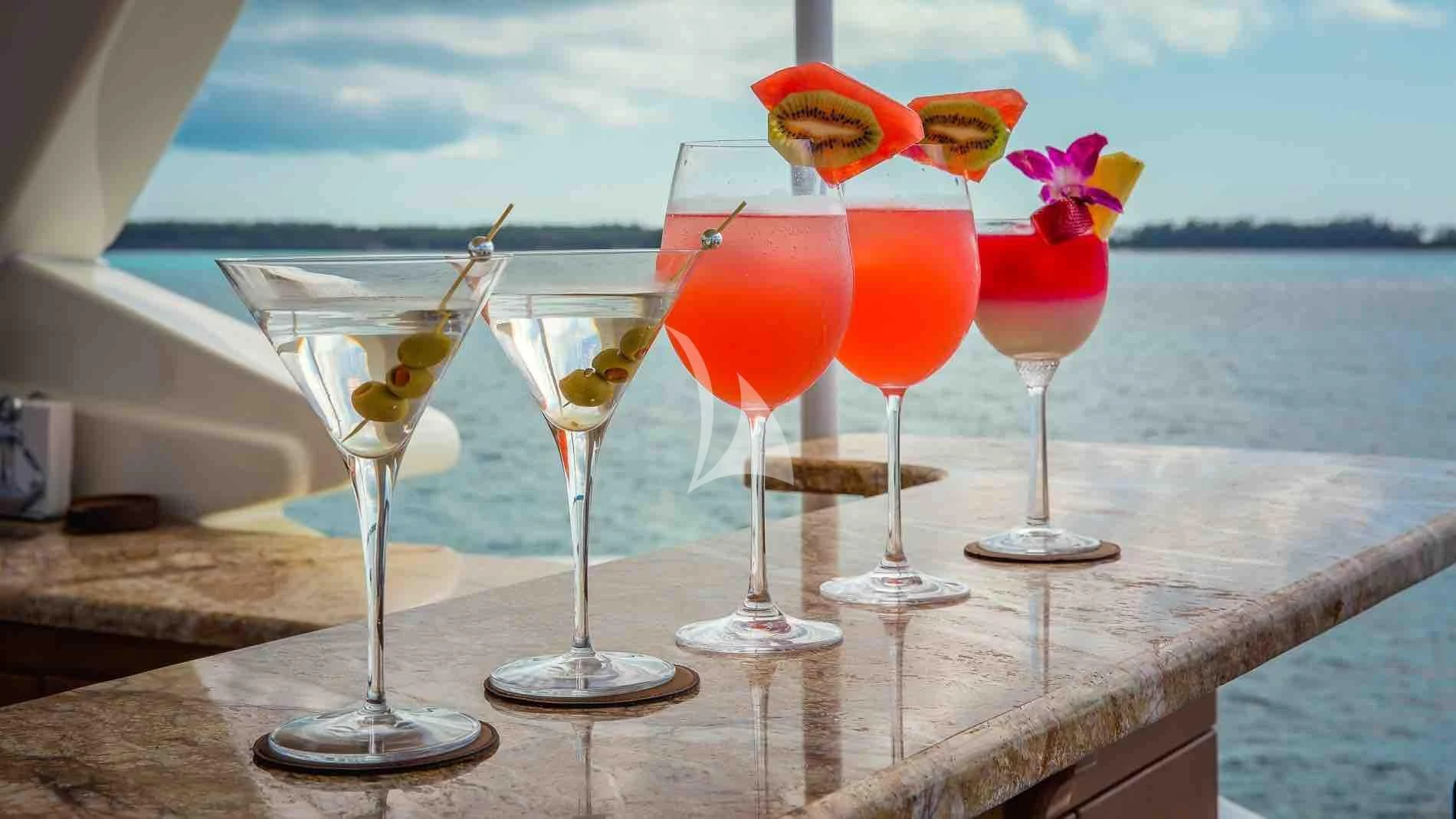 a row of glasses with colorful drinks on a table aboard ONE AND ONLY Yacht for Sale