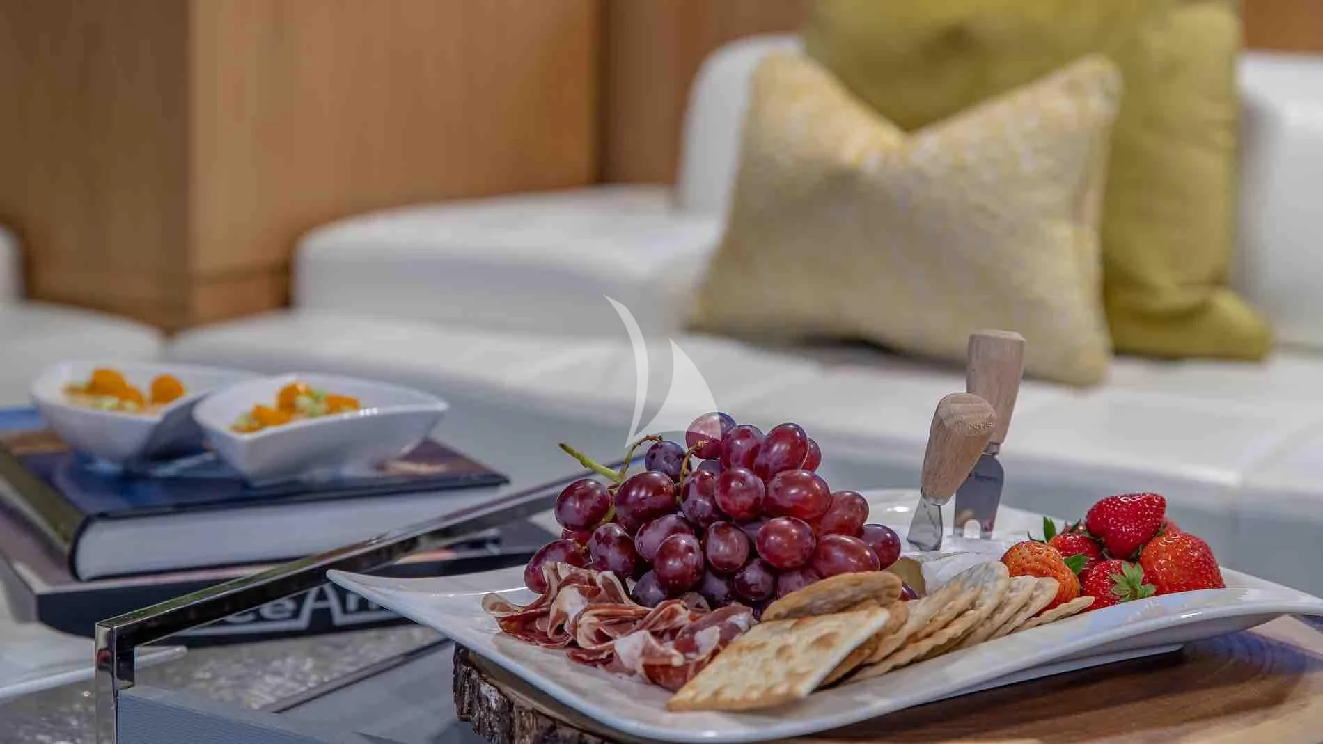 a plate of food on a table aboard ONE AND ONLY Yacht for Sale
