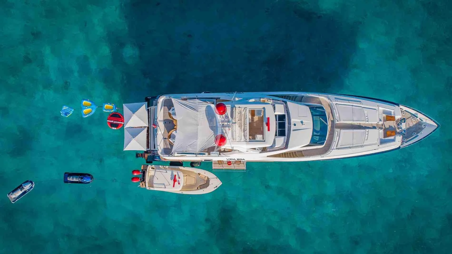 a white boat with a blue body and a white boat on it aboard ONE AND ONLY Yacht for Sale