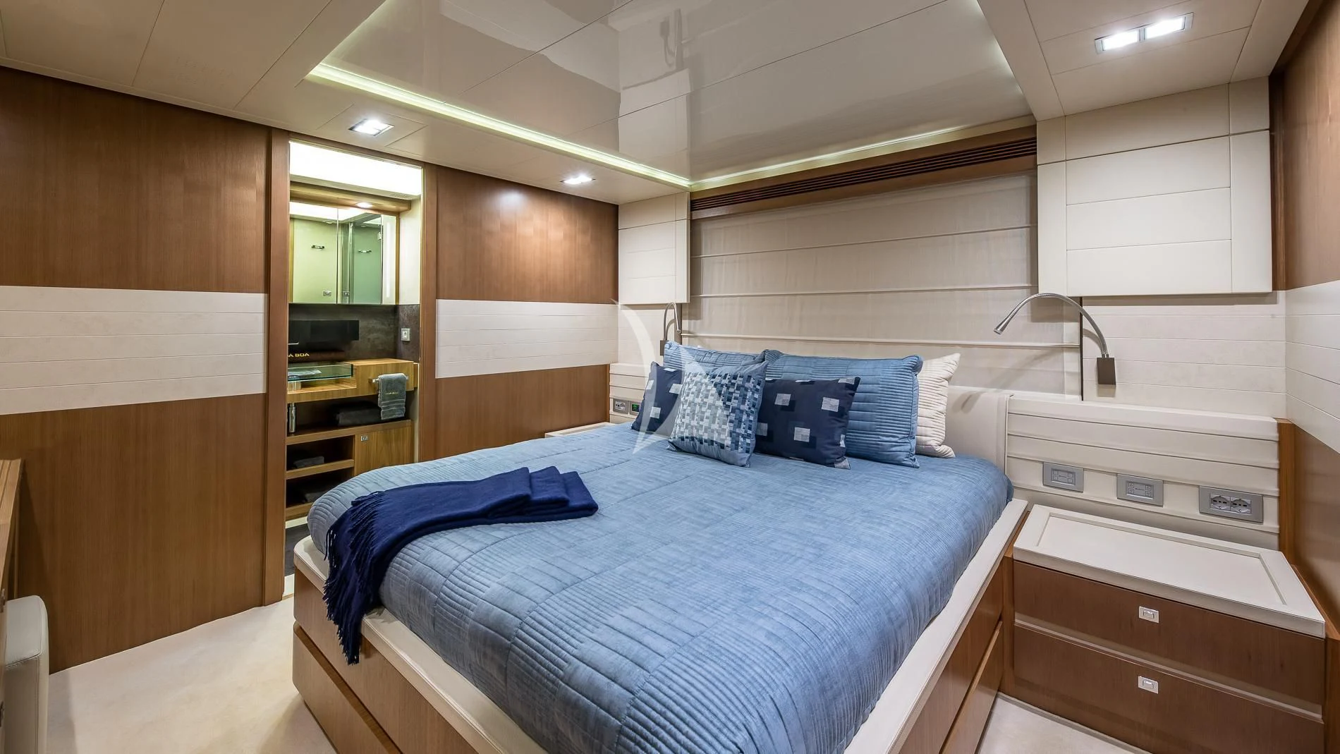 a room with a bed and a mirror aboard ONE AND ONLY Yacht for Sale