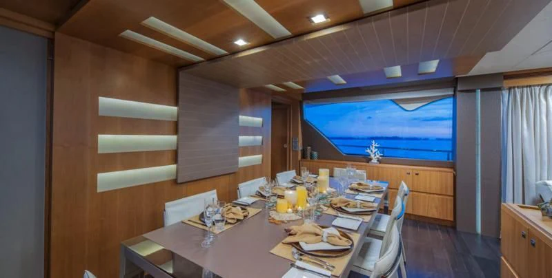 a dining table in a room aboard ONE AND ONLY Yacht for Sale