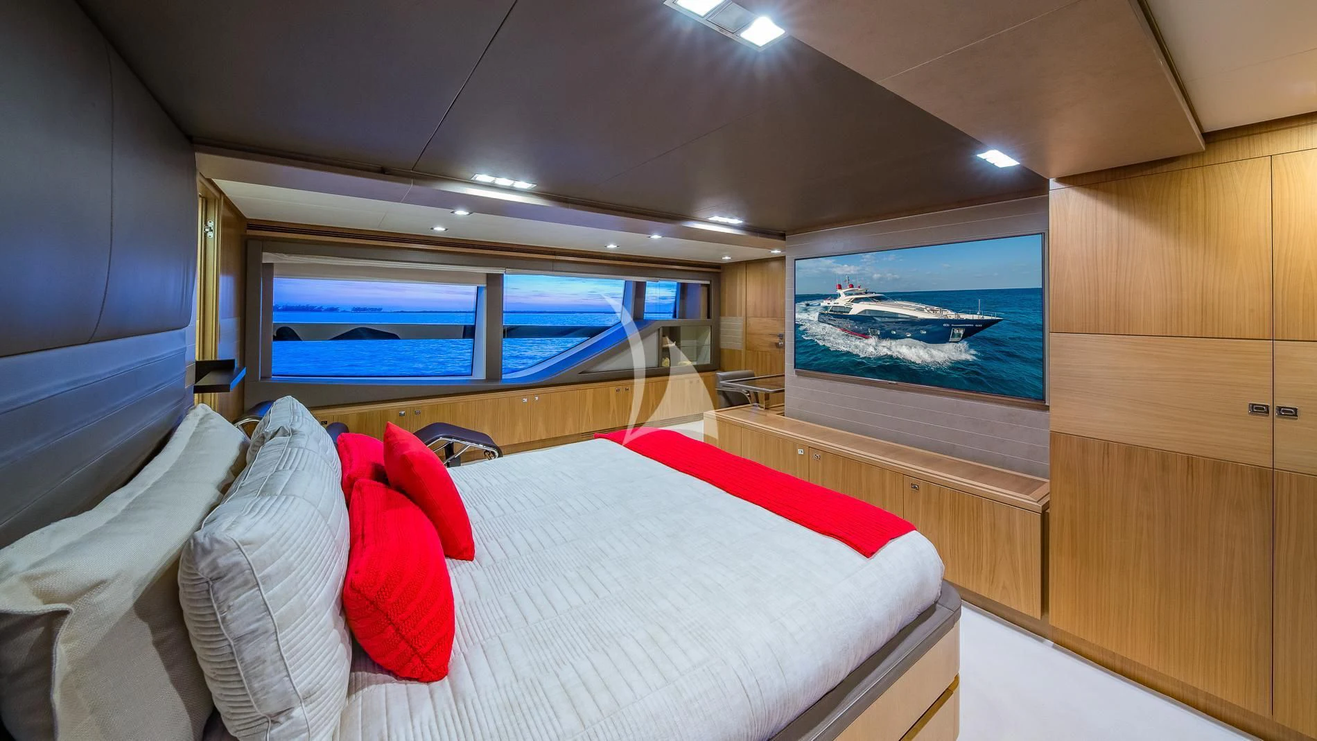 a room with a bed and a window aboard ONE AND ONLY Yacht for Sale
