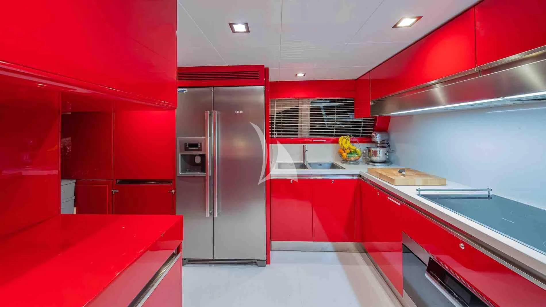 a kitchen with red cabinets aboard ONE AND ONLY Yacht for Sale