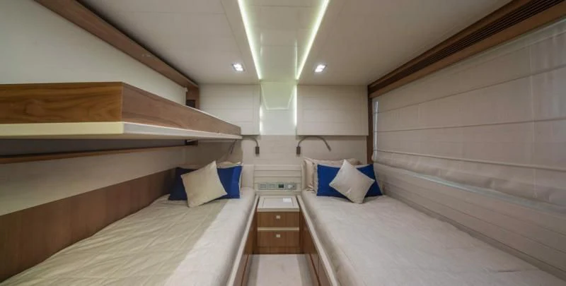 a room with a bed and a wood shelf aboard ONE AND ONLY Yacht for Sale
